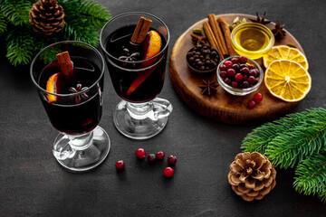 Two cups of mulled wine, spices and dry citrus fruits warming christmas drink