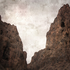 stylish textured old paper background with landscape of Gran Canaria, deep ravine Barranco Hondo