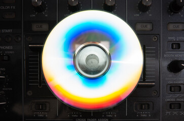 Colorful holographic CD on the dj mixer. Dj equipment