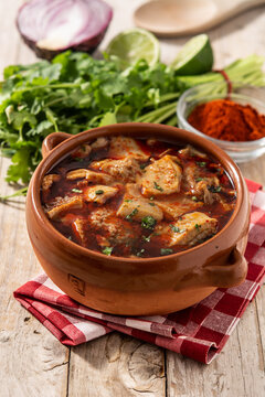 Traditional mondongo or el menudo soup on wooden table