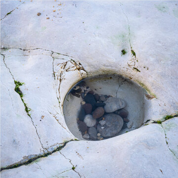 Eroded hole in chalkstone beach