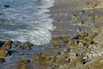 waves and rocks, breaking on the shore.