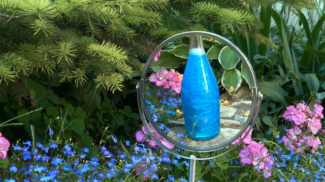 Blue elixir in the bottle is reflected in the mirror