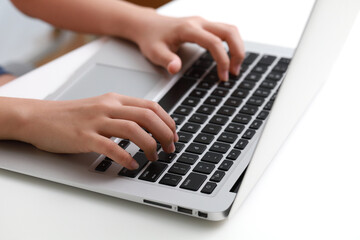 Fototapeta na wymiar Cropped hand of a teenager using laptop computer