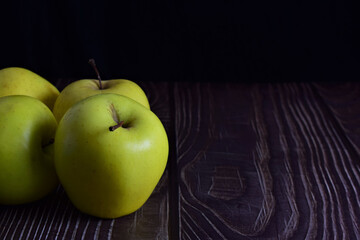 Close up. Group of fresh apples on rustic table, space for text or idea.