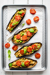 Stuffed roasted eggplants with tomatoes and fresh basil