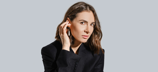 Fototapeta na wymiar Portrait of a woman touching her ear with earring