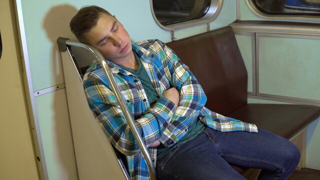 A Young Man Fell Asleep In A Subway Train. Old Subway Car