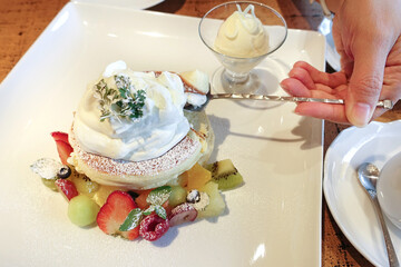 Delicious flufy fruits pancakes with ice cream. Japanese famous dessert.