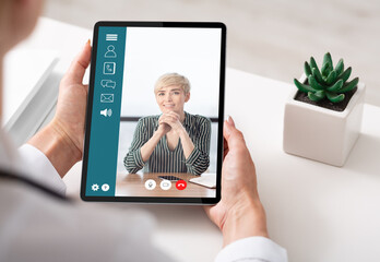 Businesswoman Holding Digital Tablet Making Video Call In Office, Cropped