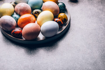 Easter eggs dyed in pastel colors with natural ingredients from red cabbage, onion, spinach, berries, turmeric, coffee. Homemade naturally dyed eggs.