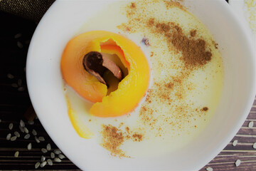 Zenith view of homemade rice pudding, with a hint of citrus and cinnamon, in a white porcelain bowl
