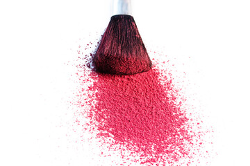 Bright pink rouge and brush close up