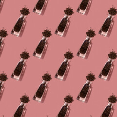 Seamless pattern with black pepper in crystal clear bottles.