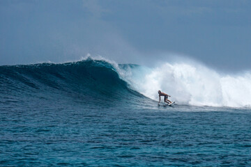 Surfer on perfect blue aquamarine wave, empty line up, perfect for surfing, clean water, Indian Ocean