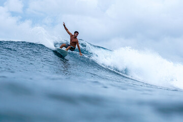 Surfer on perfect blue aquamarine wave, empty line up, perfect for surfing, clean water, Indian Ocean