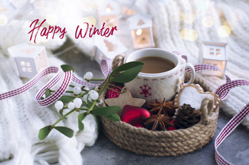 happy winter - text. Christmas decorations, ribbon, a cup of coffee, sprigs of mistletoe, knitted white scarf