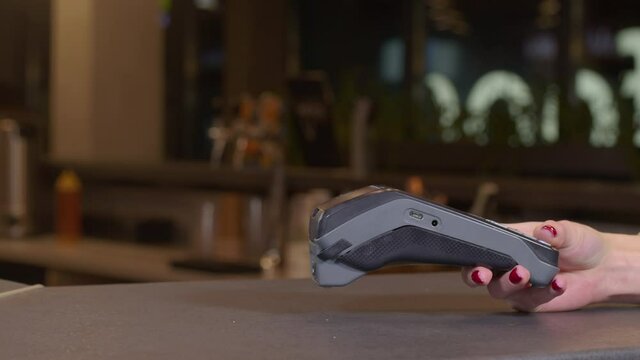 Smartphone payment. Female hand pay using nfc system and contactless card.