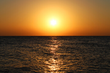 Scorching sun over the sea horizon