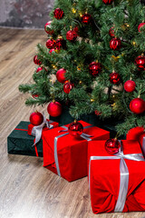 Naklejka na ściany i meble Beautiful holiday decorated room with Christmas tree with presents under it