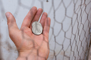 Hand holding half dollar coins