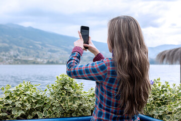 Young girl taking a picture with mobile phone