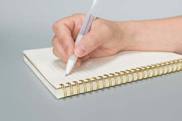 Working woman's hand. Female hand writing a note