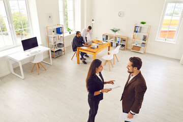 Young people meeting in modern office space, communicating and working on business projects
