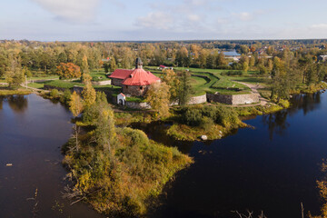 Aerial view of ancient fortress Korela in priosersk with river and park in golden autumn, red and orange colours