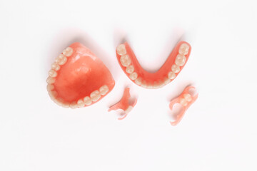 Dentures on a white background. Close-up of dentures. Dentistry is conceptual photography. Prosthetic dentistry. False teeth. Prosthetics. Close-up of plastic dentures. Teeth on a white background