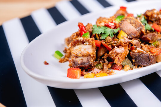 Fried Crispy Pork  On a white plate- Thai food style
