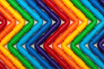 Rainbow colored plastic pipes as background