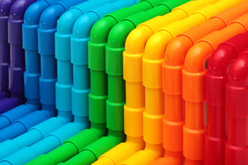 Rainbow colored plastic pipes as background