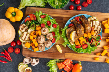 Two plates with vegetables and fish cooked  home in kitchen.