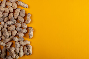 Raw nuts on a yellow background. Free space on the right. Top view.