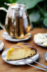 organic mango cake and herbal tea set on cafe table