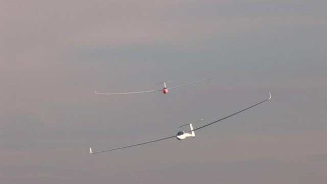 Two gliders in close formation flight in front of the swiss mountains
