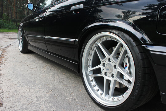 Kiev, Ukraine - May 17, 2014: BMW M5 E34 on the road in the forest. Car tires. Car wheel close up