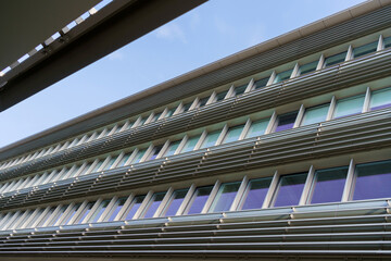 Part of a modern office building. Lots of windows and unusual architecture. High quality photo
