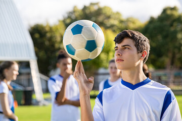 Guy spinning soccer ball on finger © Rido