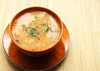 bowl of chicken soup with spice, top view
