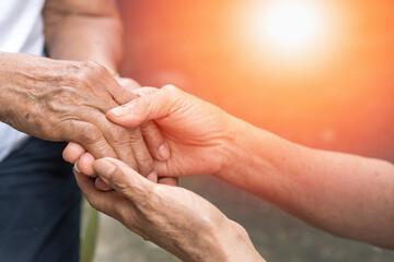 Aging society with Senior hand holding elder together in hospice care background. Philanthropy kindness to disabled old people concept. - obrazy, fototapety, plakaty