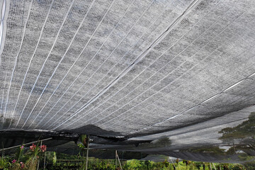 Low angle view black shading net pattern texture and background. Weaved plastic shade to protect...
