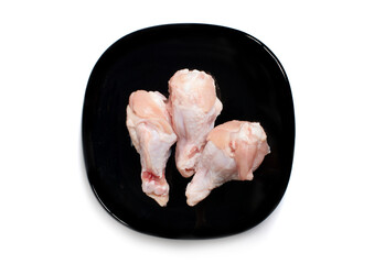 Fresh raw chicken isolated in black plate on white background