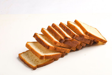 Cut of loaf bread on white against white background