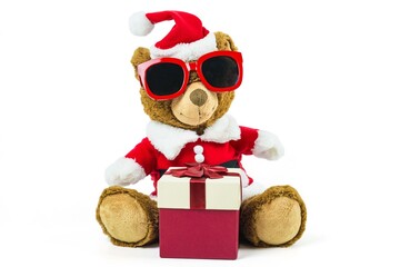 A teddy bear doll wearing santa set and glasses with red gift box isolated on white background,Christmas day and New Year's gifts