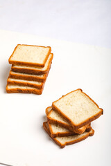 Cut of loaf bread on white against white background