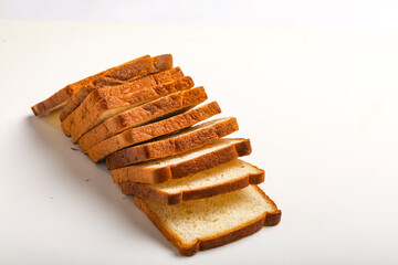 Cut of loaf bread on white against white background