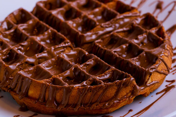 Waffles with chocolate spread isolated close up. Waffle texture.