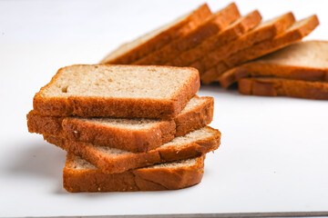Cut of loaf bread on white against white background
